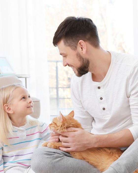 chat entouré d'un père et sa fille